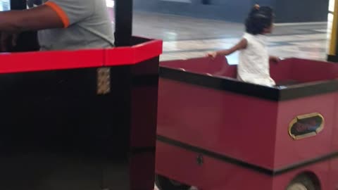 A small kid sitting in London bus