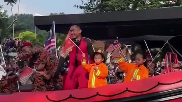 Boy accidentally points middle finger during parade