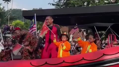 Boy accidentally points middle finger during parade