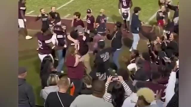 Watch this high school football team react to coach proposing to girlfriend