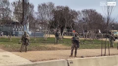 Buses, presumably carrying more soldiers, head to the Capitol