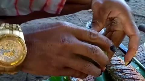 eating mackerel fish fried in palm oil