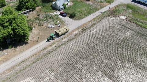 Long video of Chance delivering and stacking bales