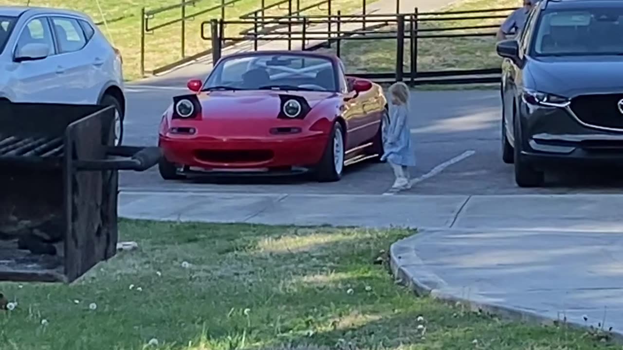 Car Winks Its Headlights at Unsuspecting Kid