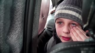 'We left our Dad in Kyiv' -little boy chokes back tears