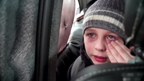 'We left our Dad in Kyiv' -little boy chokes back tears
