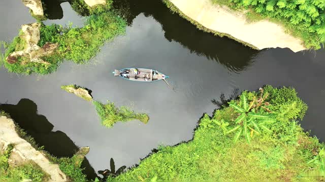 Aerial View Of A Boat Sailing Sailing Through Beautiful Nature