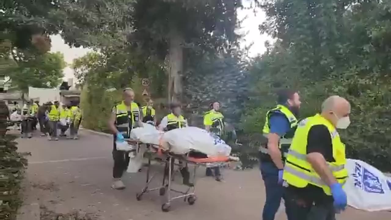 Carrying out the dead from Kibbutz Be’eri.