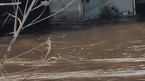 Refrigerator stuck under a bridge