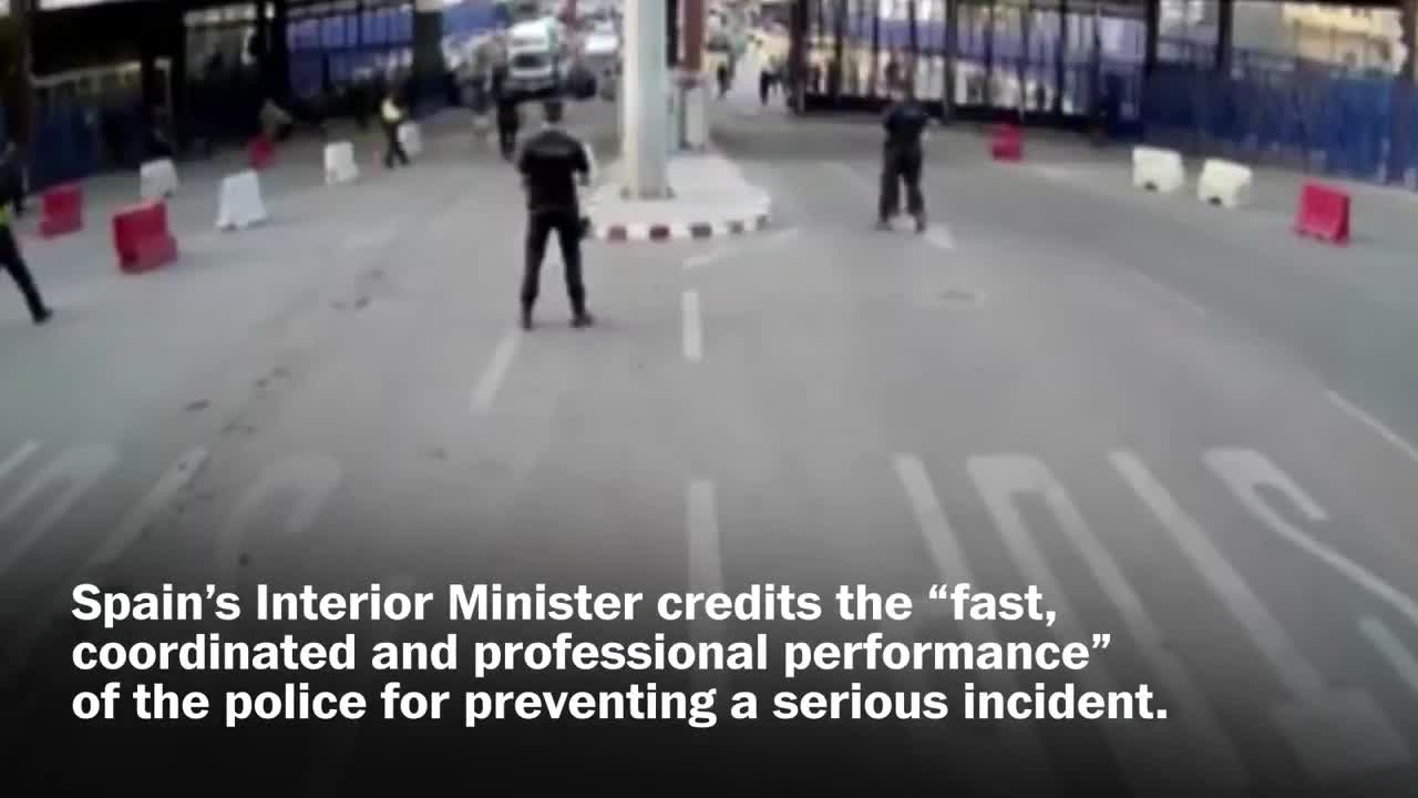 Spanish police throw traffic barrier at knife-wielding man