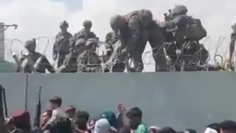 Toddlers and children pulled over wall by U.S. soldiers outsid Kabul airport 8-19-21