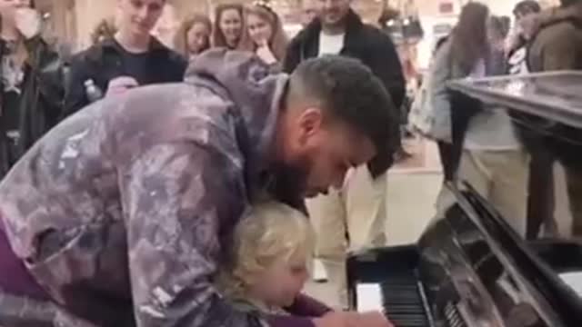 Curious little boy adorably kicks performer off his piano so he can try playing