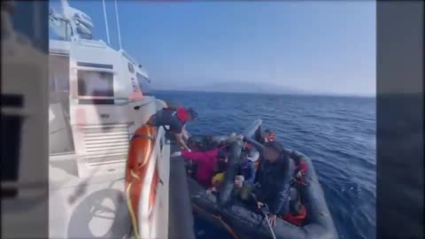 Shows how masked men onboard the Greek coast guard