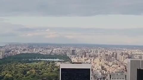 UFO ABDUCING SEVERAL THINGS ON TOP OF A BUILDING