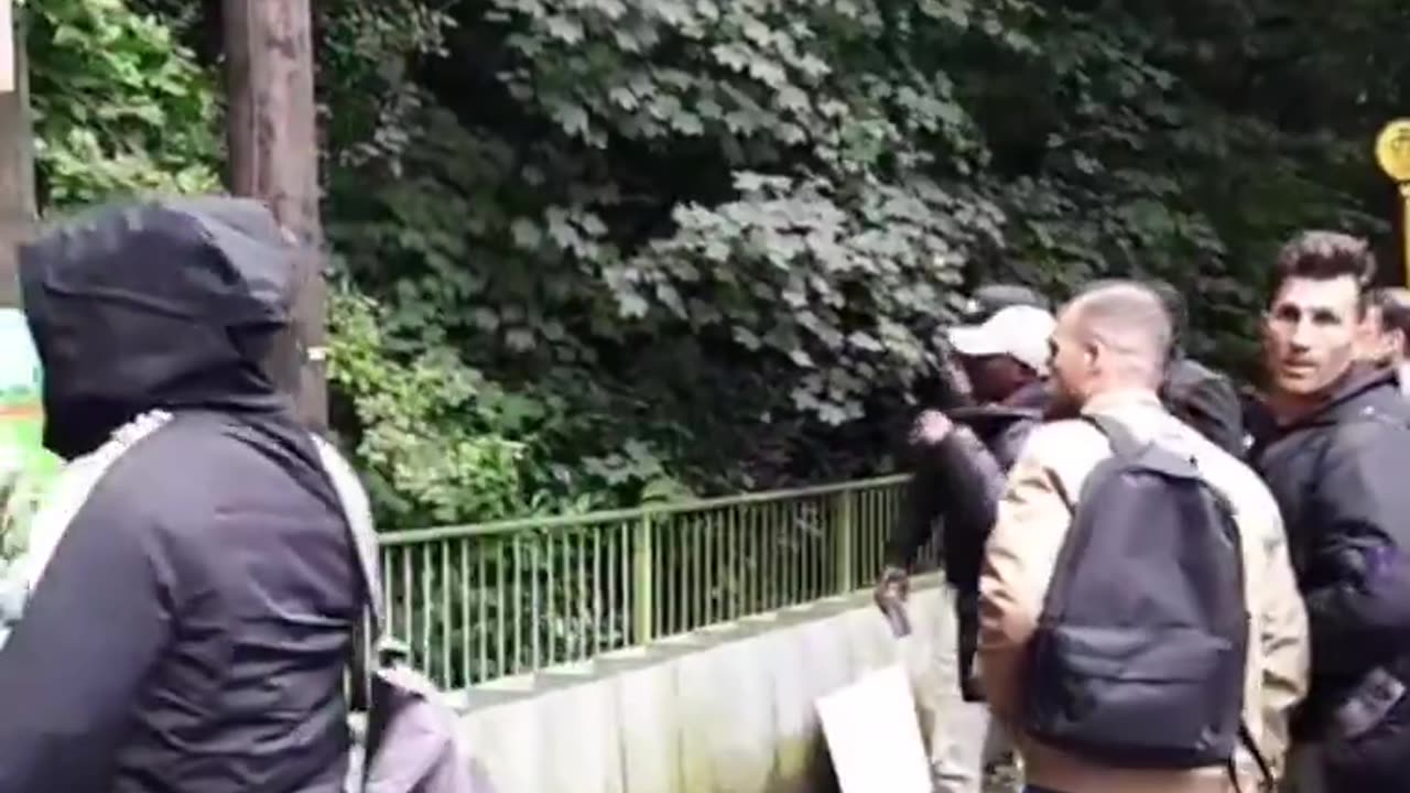 An Irish man is shocked as the public bus drops off a crowd of male migrants