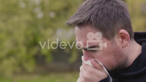 Sick Man At Park Coughing In A Handkerchief