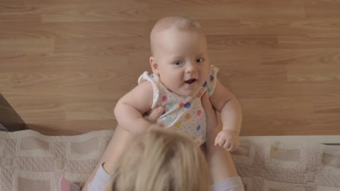 Mother making her baby laugh