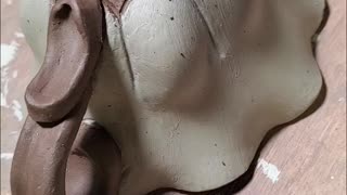 Carving onto a teacup.