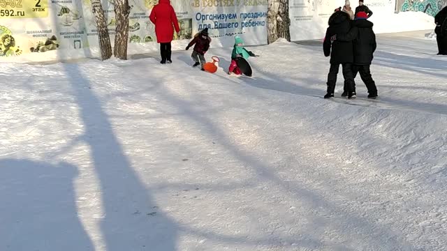 children ride down the hill