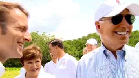 Biden Oogles Over Russian Man’s Biceps