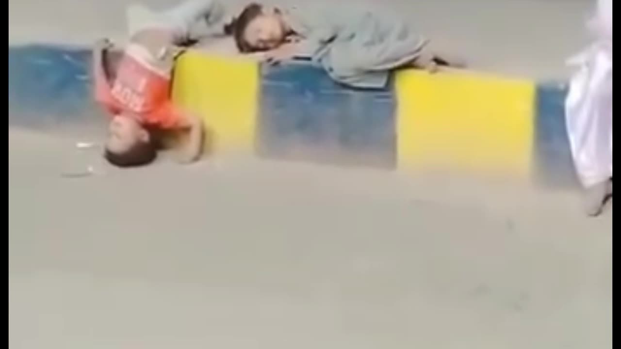 Kids sleeping in center Foot Path of Road | Pakistan