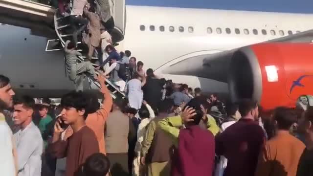 Residents in Afghanistan flock to a Kam Air Airbus A340