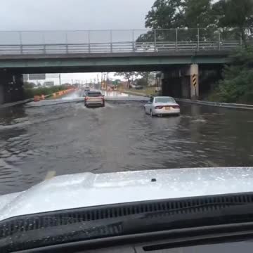 Vehicles drive through flooded underpass in Lindenhurst, NY