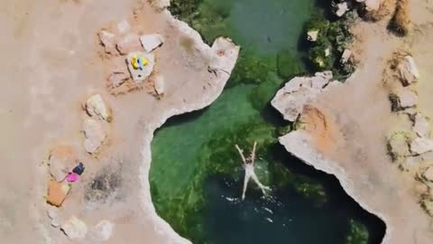 A secluded hot spring in an open field