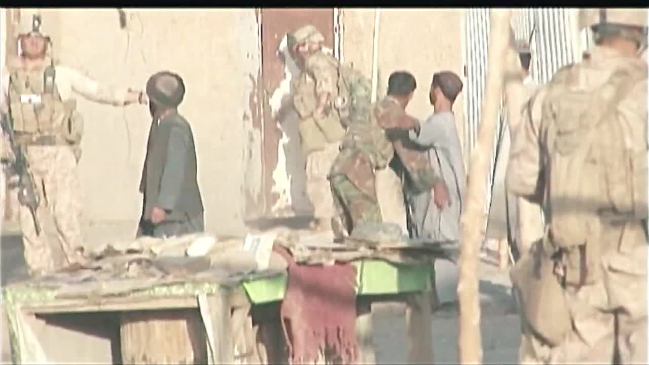 Scenes of American troops and Afghan soldiers raiding a bazaar and checking entry and exit points.