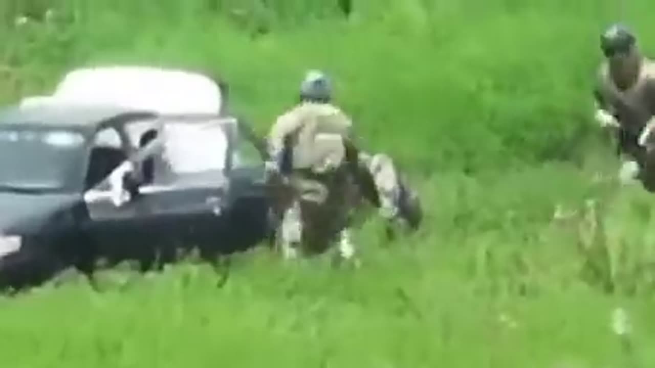 AFU soldiers - shot a car with civilians and are trying to perform CPR on a child.