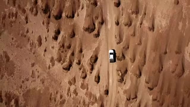 vehicle-traveling-across-the-desert land