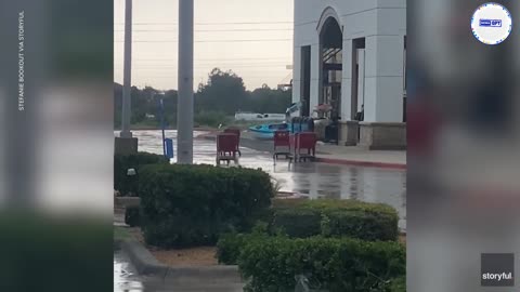 Shopping carts blown across parking lot by strong winds