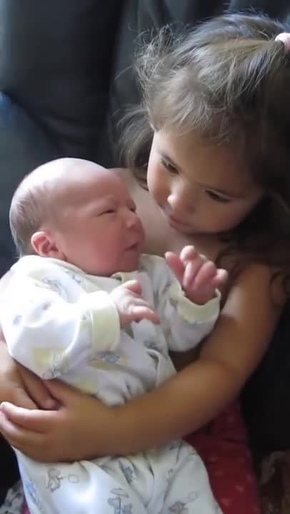 Big Sister Preciously Holds Newborn Baby Brother