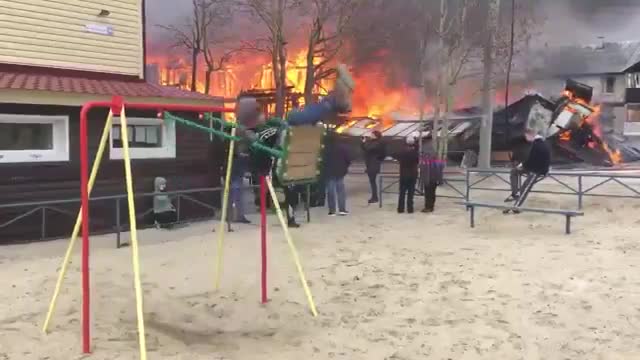 Boy enjoys and swings while home burns down