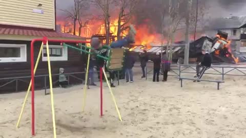 Boy enjoys and swings while home burns down