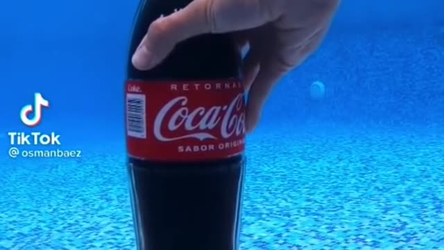 Opening of Lid of Coke in Water.