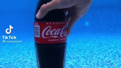 Opening of Lid of Coke in Water.