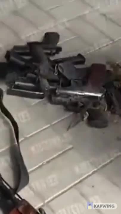Russian soldiers show captured Ukrainian military firearms