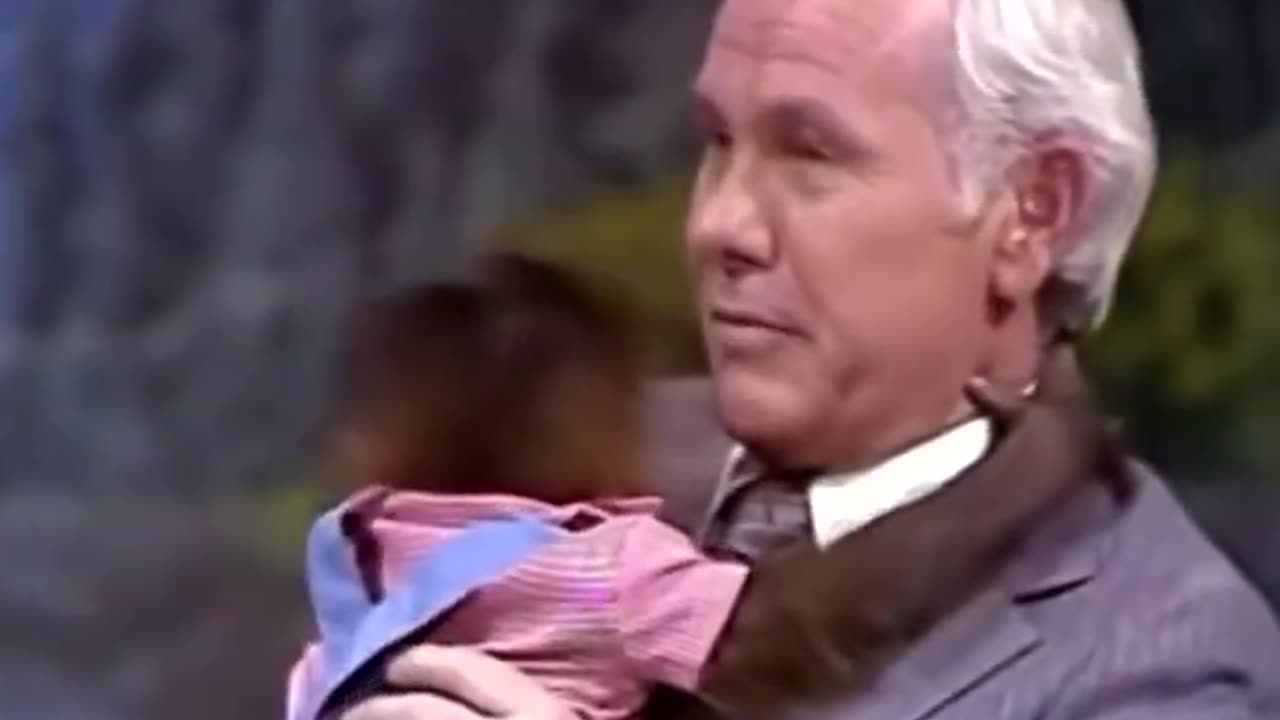 Johnny Carson hugging a baby orangutan, 1978