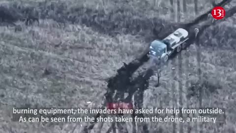 Russians who came to their fellow soldiers’ rescue, seek to put out fire in burning equipment