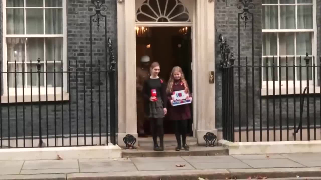 Rishi Sunak and wife Akshata don poppies outside 10 Downing Street