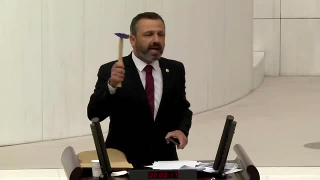 Turkish lawmaker smashes phone with hammer in parliament to protest social media bill