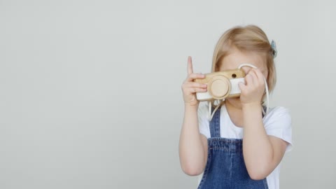 A Young Girl Playing As Photographer