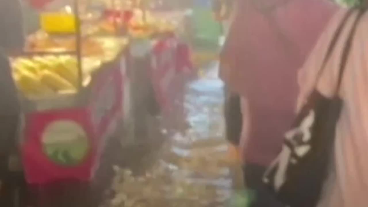 Heavy rain and floods sweep a market in Bangkok