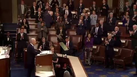 Democrats stand for a round of applause as Biden talks about funding the police