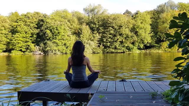 Women Meditating On Deck In Yoga Position