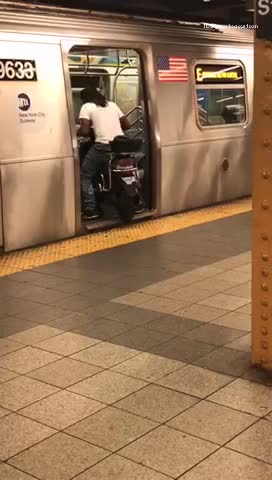 Man in white shirt drives motorcycle into subway train