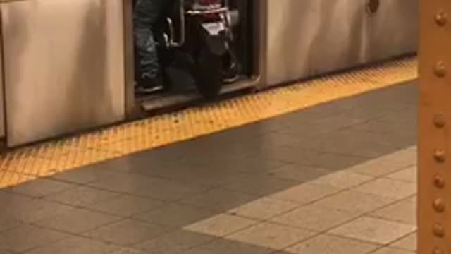 Man in white shirt drives motorcycle into subway train