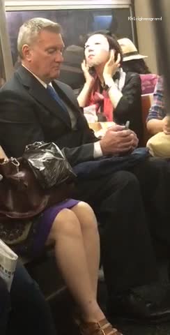 Woman puts on face mask on train