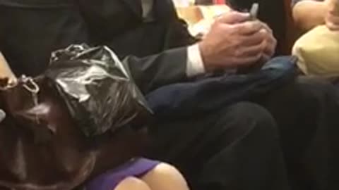 Woman puts on face mask on train